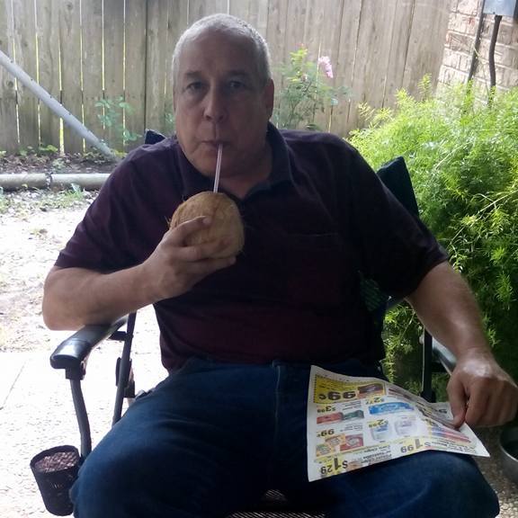 Thomas relaxing drinking a coconut.